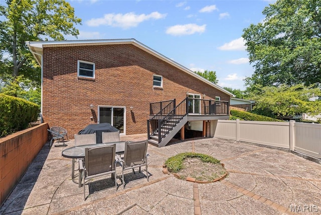 46 Coronation Dr, Millstadt, IL 62260 - rear view of house featuring a patio, stairway, brick siding, and a wooden deck