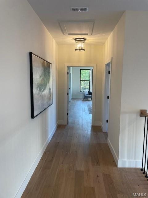 8145 University Dr, Clayton, MO 63105 - hallway with wood finished floors and attic access