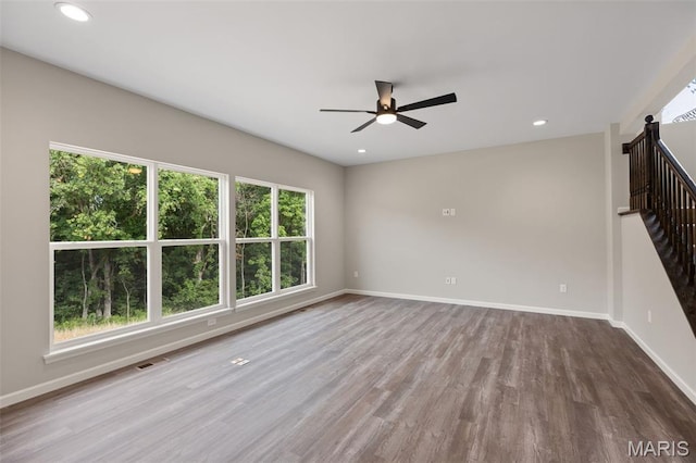 2213 Rule Ave, Maryland Heights, MO 63146 - empty room with ceiling fan, wood finished floors, recessed lighting, and stairs