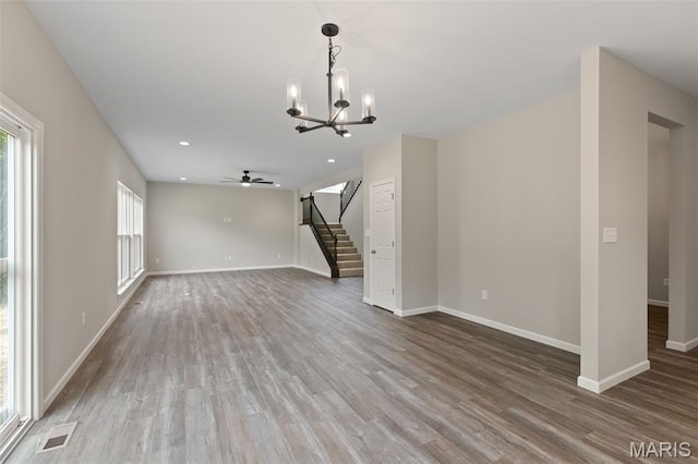 2213 Rule Ave, Maryland Heights, MO 63146 - unfurnished living room featuring stairway, wood finished floors, a chandelier, ceiling fan, and recessed lighting