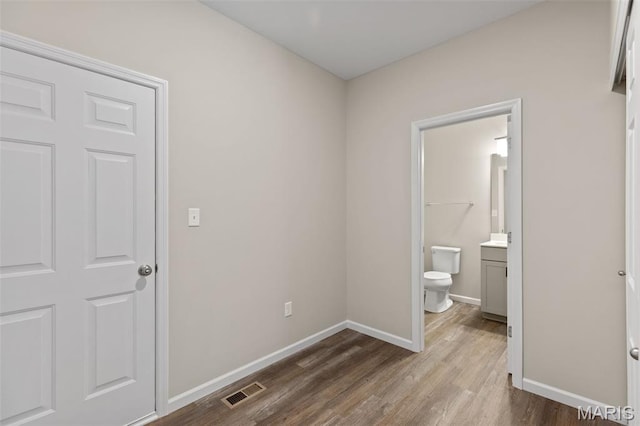 2213 Rule Ave, Maryland Heights, MO 63146 - unfurnished bedroom featuring dark wood-style floors and ensuite bath