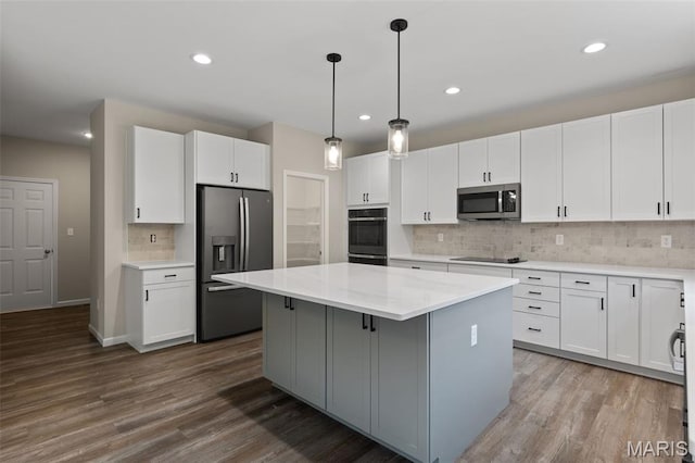 2213 Rule Ave, Maryland Heights, MO 63146 - kitchen featuring black appliances, a kitchen island, decorative backsplash, white cabinets, and recessed lighting