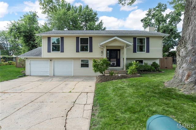 15 Ann Dr, Saint Peters, MO 63376 - raised ranch with a chimney, concrete driveway, and an attached garage
