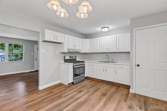 17 Edward Dr, Saint Peters Township, MO 63304 - kitchen featuring stainless steel gas range oven, light countertops, white cabinets, and light wood-type flooring