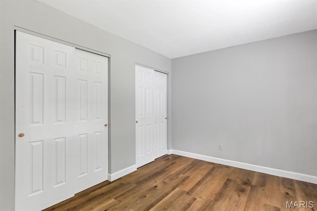 17 Edward Dr, Saint Peters Township, MO 63304 - unfurnished bedroom featuring dark wood-type flooring and two closets