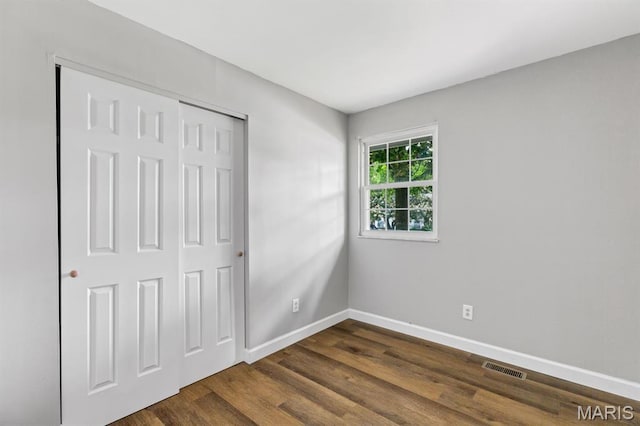 17 Edward Dr, Saint Peters Township, MO 63304 - unfurnished bedroom with dark wood-style flooring and a closet