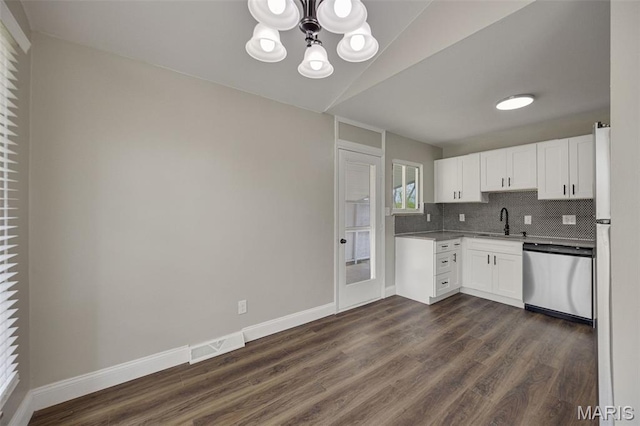 229 Orchard Ave, Ballwin, MO 63021 - kitchen featuring stainless steel dishwasher, a chandelier, dark wood-style flooring, white cabinets, and decorative backsplash