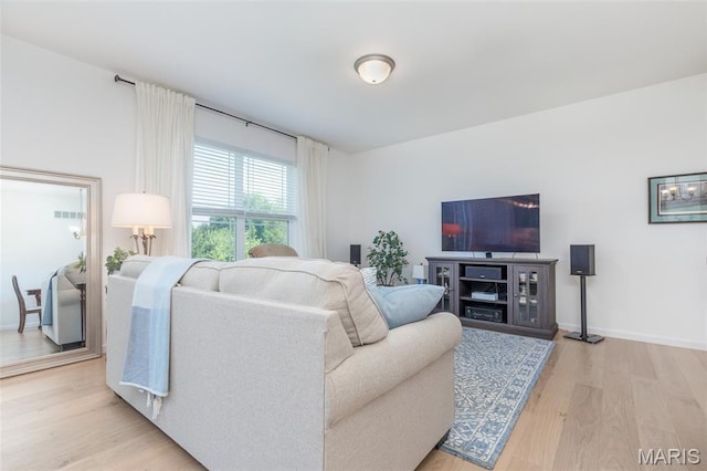 9 Vera Pl, Saint Charles, MO 63303 - living room featuring light wood-style flooring and baseboards