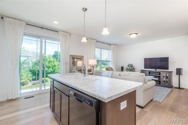 9 Vera Pl, Saint Charles, MO 63303 - kitchen with dishwasher, light countertops, light wood-style flooring, open floor plan, and decorative light fixtures