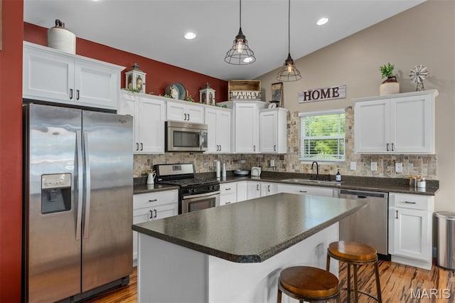 1145 Nassau Dr, Edwardsville, IL 62025 - kitchen with stainless steel appliances, dark countertops, white cabinetry, and recessed lighting