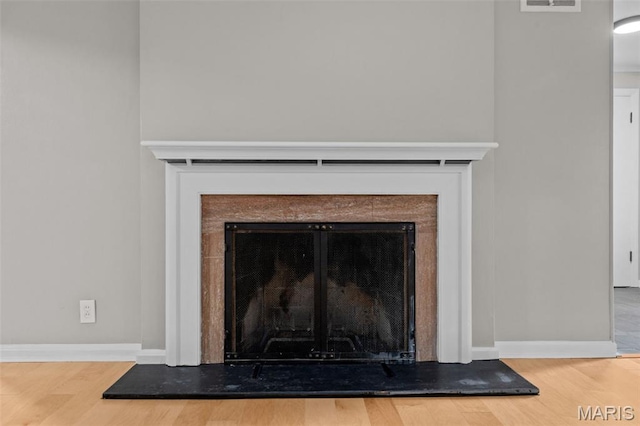 7315 Ahern Ave, University City, MO 63130 - detailed view of a fireplace with raised hearth and wood finished floors