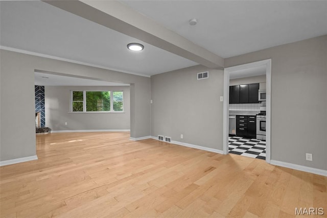 7315 Ahern Ave, University City, MO 63130 - unfurnished living room featuring light wood-style flooring and a fireplace