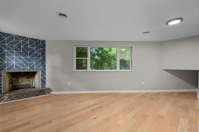 7315 Ahern Ave, University City, MO 63130 - unfurnished living room with wood finished floors and a tile fireplace
