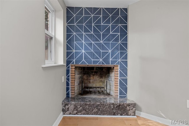 7315 Ahern Ave, University City, MO 63130 - detailed view of a tiled fireplace and wood finished floors