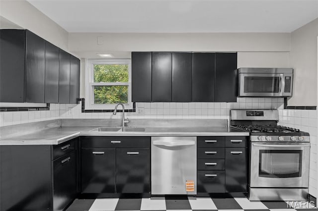 7315 Ahern Ave, University City, MO 63130 - kitchen with appliances with stainless steel finishes, dark cabinetry, and light countertops