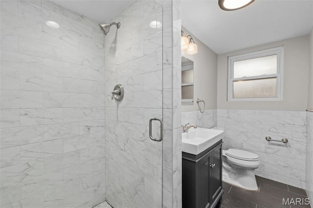 7315 Ahern Ave, University City, MO 63130 - full bathroom featuring tile walls, a shower stall, vanity, and a wainscoted wall