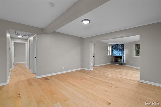 7315 Ahern Ave, University City, MO 63130 - unfurnished living room with light wood-type flooring and a fireplace