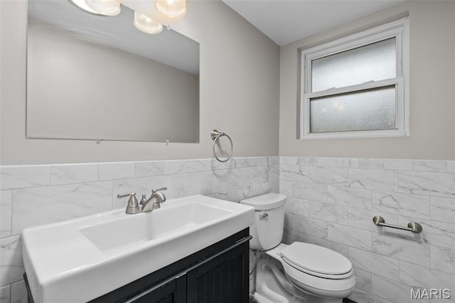 7315 Ahern Ave, University City, MO 63130 - bathroom with tile walls, vanity, and a wainscoted wall