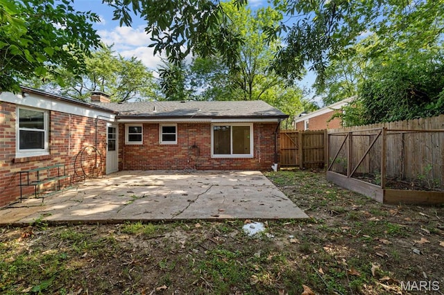 7315 Ahern Ave, University City, MO 63130 - rear view of house with a patio area, brick siding, a garden, and a chimney