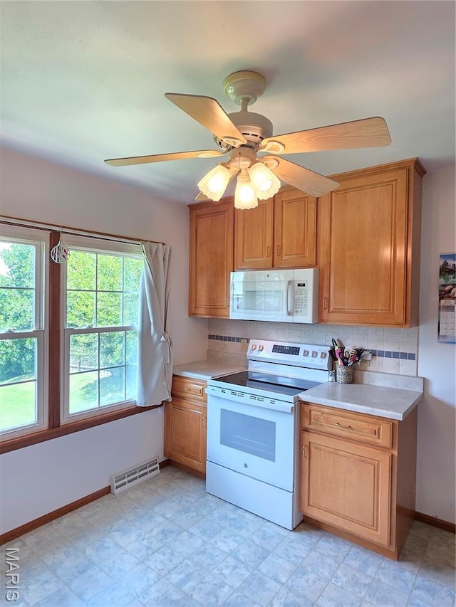 320 W 6th St, Washington, MO 63090 - kitchen with white appliances, decorative backsplash, and light countertops