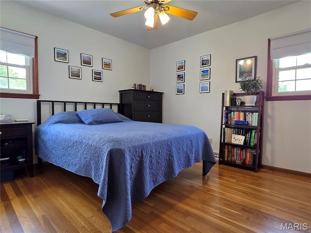 320 W 6th St, Washington, MO 63090 - bedroom with wood finished floors, multiple windows, and a ceiling fan