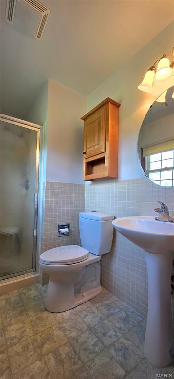 320 W 6th St, Washington, MO 63090 - full bathroom with tile walls, a stall shower, and wainscoting