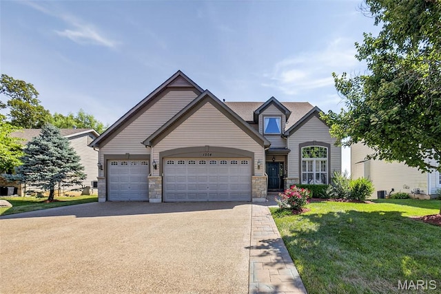1304 Forest Way, Wentzville, MO 63385 - view of front of home with concrete driveway, a garage, a front lawn, and stone siding