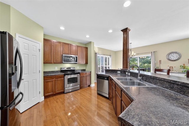 1304 Forest Way, Wentzville, MO 63385 - kitchen featuring stainless steel appliances, dark countertops, light wood-style floors, recessed lighting, and a chandelier