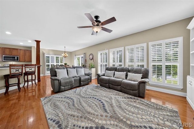 1304 Forest Way, Wentzville, MO 63385 - living room featuring a chandelier, a ceiling fan, light wood finished floors, recessed lighting, and decorative columns