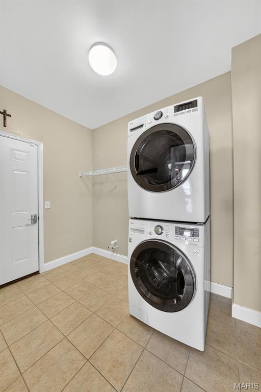 1304 Forest Way, Wentzville, MO 63385 - laundry area with estacked washer and dryer and light tile patterned floors