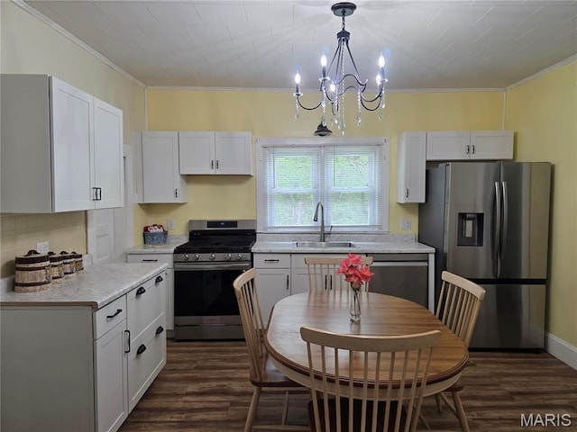 1414 Newton Ave, Johnston City, IL 62951 - kitchen featuring appliances with stainless steel finishes, crown molding, dark wood-style flooring, white cabinetry, and light countertops