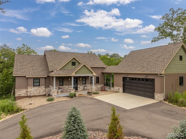 2740 Tyrol View Ct, Innsbrook, MO 63390 - craftsman-style house featuring a shingled roof, stone siding, and covered porch