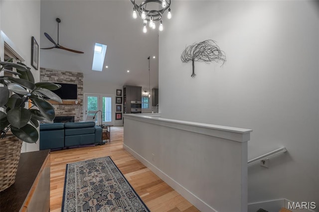 2740 Tyrol View Ct, Innsbrook, MO 63390 - corridor with a high ceiling, a skylight, light wood-style floors, and an upstairs landing