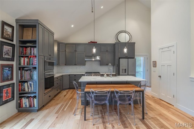 2740 Tyrol View Ct, Innsbrook, MO 63390 - kitchen featuring high vaulted ceiling, gray cabinets, refrigerator with ice dispenser, light wood finished floors, and tasteful backsplash