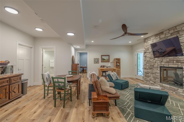 2740 Tyrol View Ct, Innsbrook, MO 63390 - living area featuring light wood-style flooring, a ceiling fan, a stone fireplace, and recessed lighting