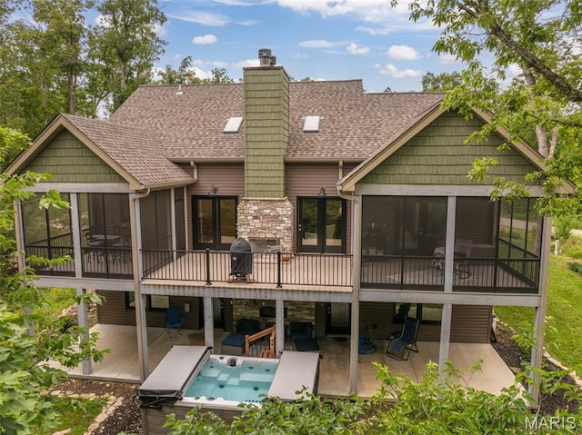 2740 Tyrol View Ct, Innsbrook, MO 63390 - rear view of property featuring a sunroom, a patio, roof with shingles, stone siding, and a chimney