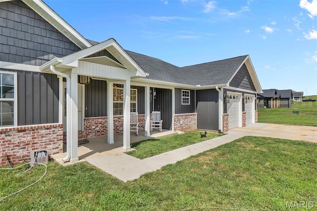 236 Haydens Trl, Jackson, MO 63755 - view of side of property with board and batten siding, covered porch, brick siding, and an attached garage