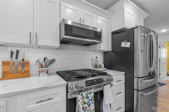 236 Haydens Trl, Jackson, MO 63755 - kitchen with appliances with stainless steel finishes, white cabinets, light stone counters, backsplash, and recessed lighting