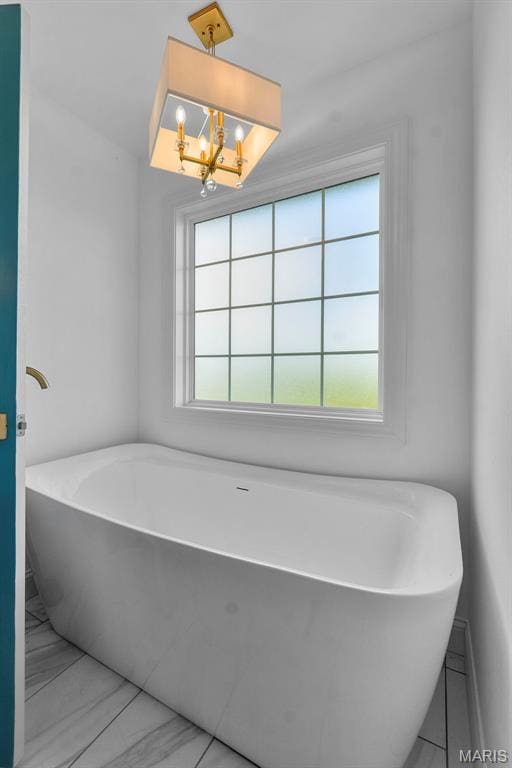236 Haydens Trl, Jackson, MO 63755 - bathroom featuring healthy amount of natural light, a soaking tub, and a chandelier
