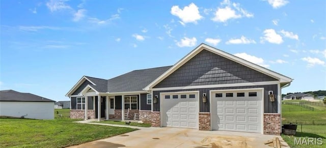 236 Haydens Trl, Jackson, MO 63755 - craftsman house featuring brick siding, a garage, a front lawn, concrete driveway, and board and batten siding