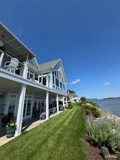 807B Wind Rivers Dr, Grafton, IL 62037 - back of property with a lawn, a water view, and a balcony