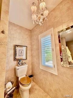 807B Wind Rivers Dr, Grafton, IL 62037 - bathroom featuring a chandelier, tile walls, and tile patterned flooring