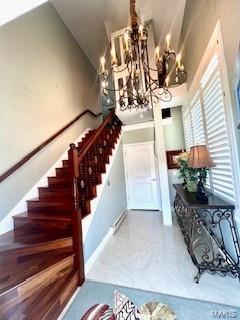 807B Wind Rivers Dr, Grafton, IL 62037 - foyer with a chandelier, stairs, and high vaulted ceiling