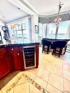807B Wind Rivers Dr, Grafton, IL 62037 - bar featuring wine cooler, plenty of natural light, light tile patterned flooring, a chandelier, and ornamental molding