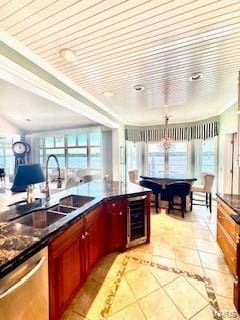 807B Wind Rivers Dr, Grafton, IL 62037 - kitchen featuring stainless steel dishwasher, wine cooler, dark countertops, reddish brown cabinets, and light tile patterned floors