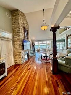 807B Wind Rivers Dr, Grafton, IL 62037 - living room featuring a fireplace, wood finished floors, and decorative columns