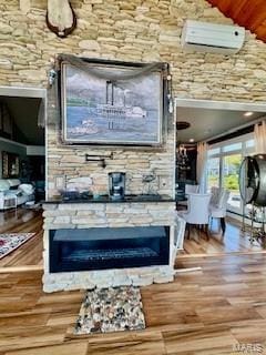 807B Wind Rivers Dr, Grafton, IL 62037 - living room featuring a glass covered fireplace, wood finished floors, and lofted ceiling