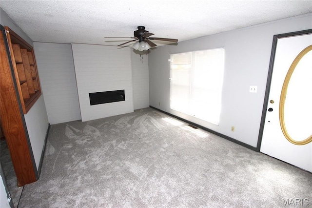 420 Lake Dr, Bonne Terre, MO 63628 - unfurnished living room featuring a ceiling fan, carpet floors, a textured ceiling, and a fireplace