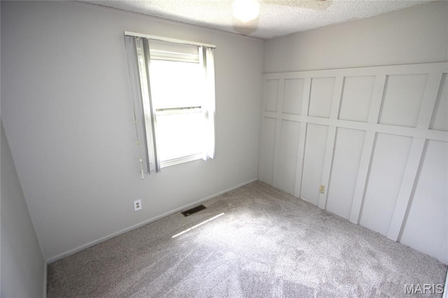 420 Lake Dr, Bonne Terre, MO 63628 - unfurnished bedroom with carpet flooring, multiple windows, and a textured ceiling