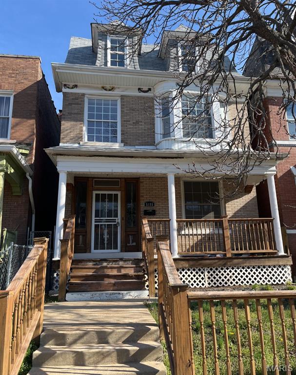 5185 Enright Ave, Saint Louis, MO 63108 - american foursquare style home featuring brick siding and a porch